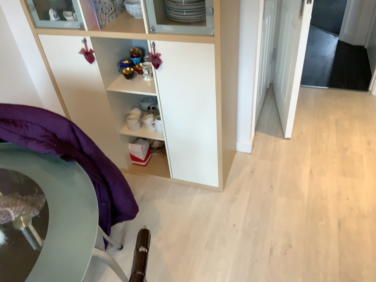 A photograph of a cabinet, chair and floor